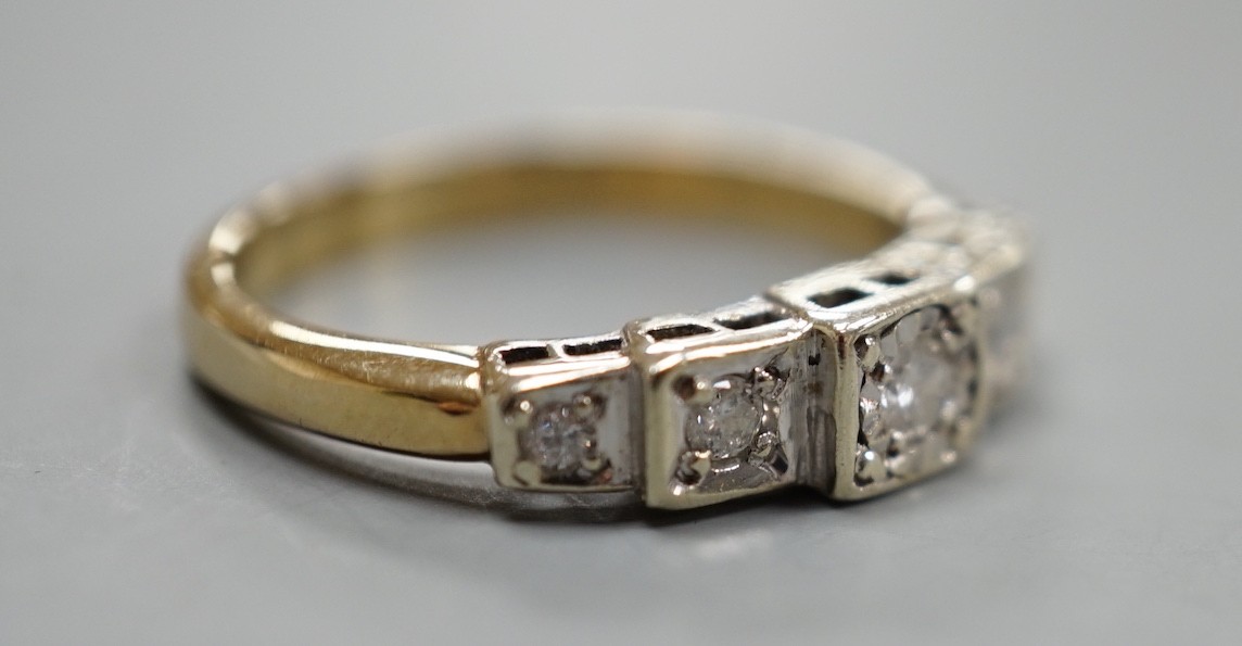 A yellow metal and graduated illusion set five stone diamond half hoop ring, size M/N, gross weight 3.2 grams.